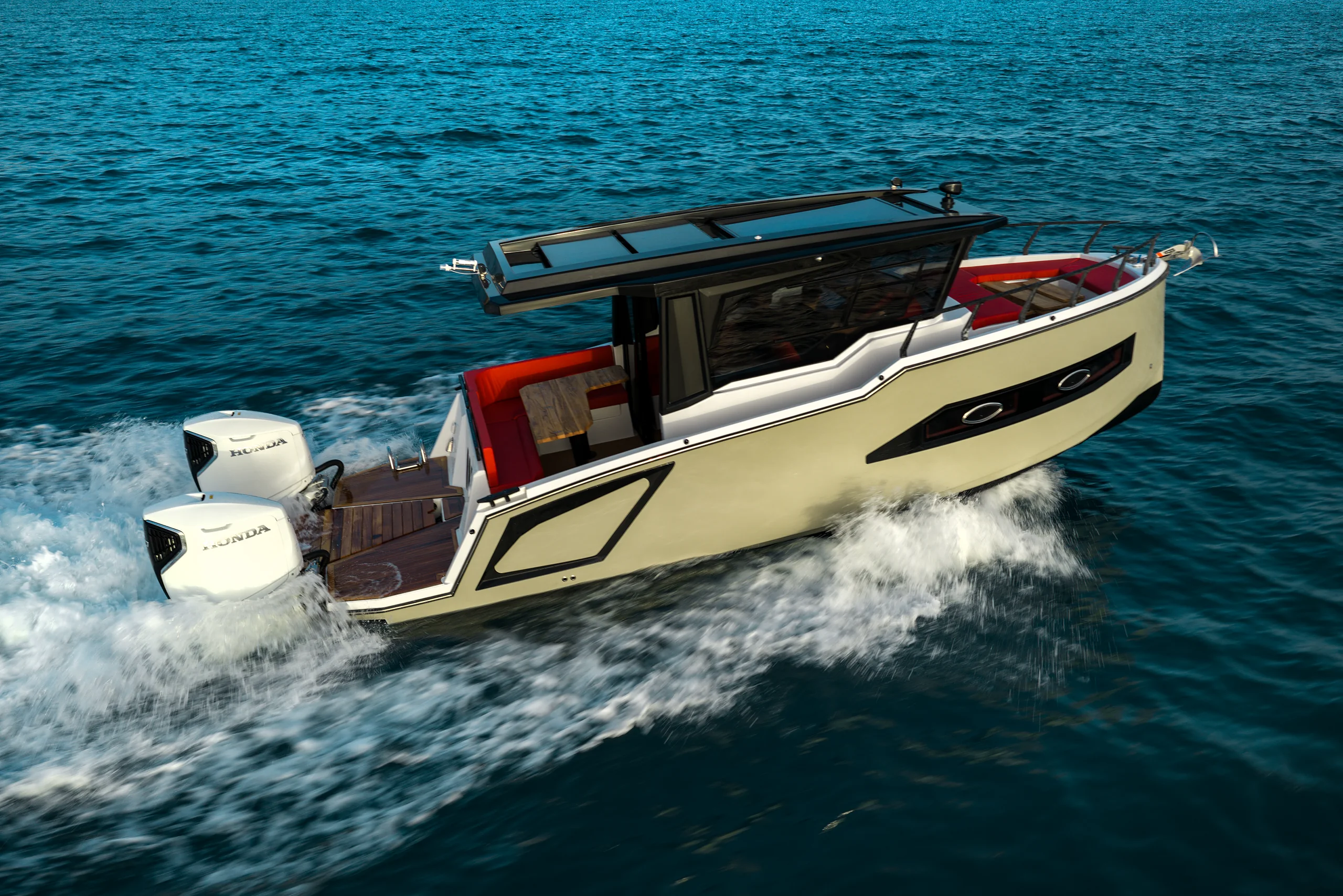 A cream-hulled Westhan 8.50 running fast over deep blue water, red upholstery in her cockpit